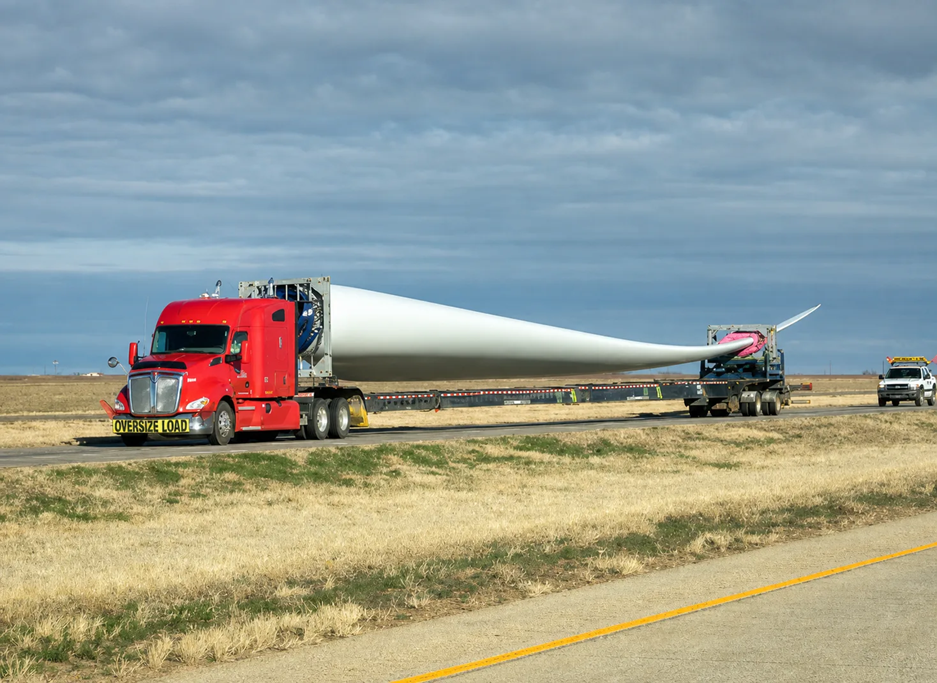 Modern wind turbine blades are very large and require expert riggers to raise them into position.